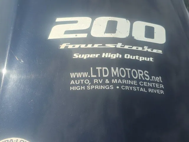 Slide: The Image of Close-up of an outboard motor labeled "200 fourstroke Super High Output" with dealer information. - 10