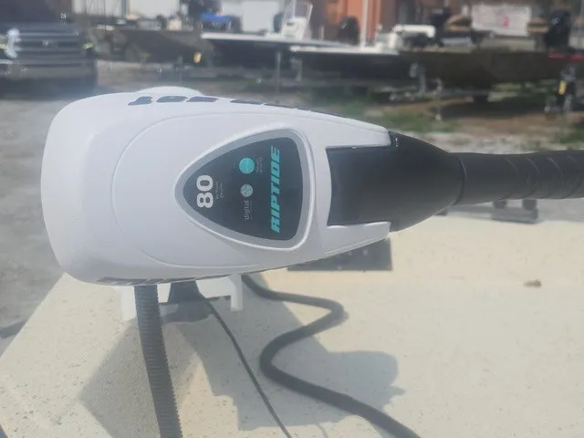 Slide: The Image of Close-up of a boat motor labeled "Riptide 80" on a 2012 Xpress H22B Bay. - 30