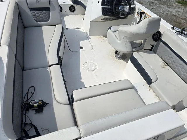 Slide: The Image of The image shows the cockpit of a 2021 Hurricane SunDeck Sport 192 RL OB with gray upholstery. - 12