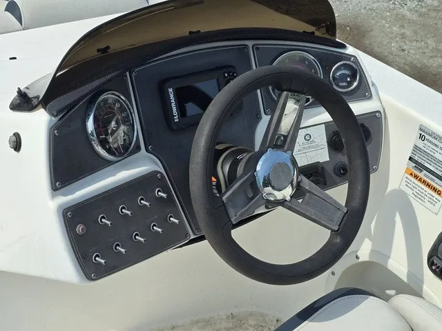 Slide: The Image of The image shows the helm of a 2021 Hurricane SunDeck Sport 192 RL OB with steering wheel and gauges. - 21