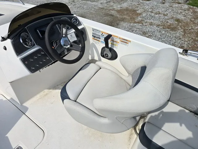 Slide: The Image of The image shows the cockpit of a 2021 Hurricane SunDeck Sport 192 RL OB with a helm and cushioned seat. - 20