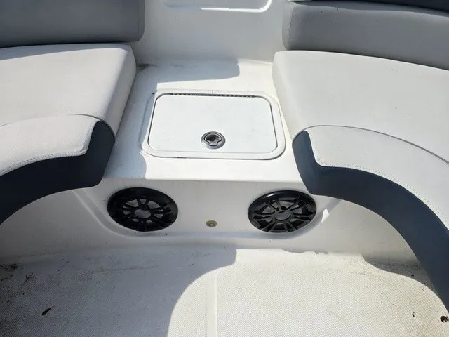 Slide: The Image of The image shows a boat seating area with white and gray cushions and speakers. - 16