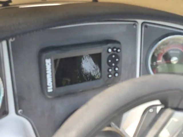 Slide: The Image of Close-up of a boat dashboard featuring a Lowrance screen and a tachometer. - 23