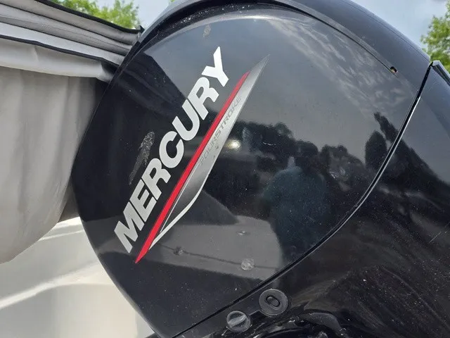 Slide: The Image of A Mercury outboard motor is mounted on a boat. The sky is partly cloudy. - 9