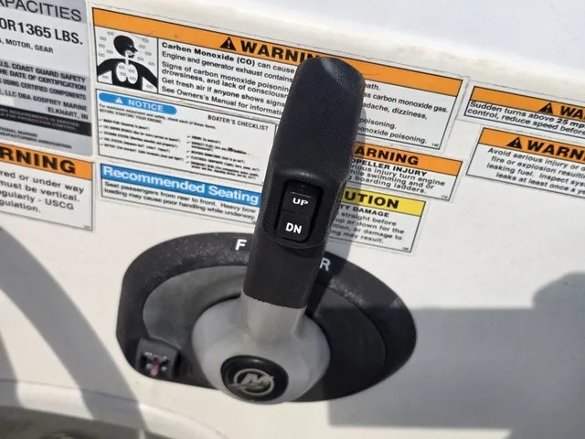 Slide: The Image of Close-up of a boat control lever with warning labels and instructions. - 25