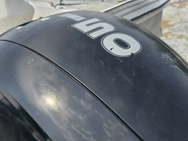 Slide: The Image of Close-up of an outboard motor with "115" written on it. - 10