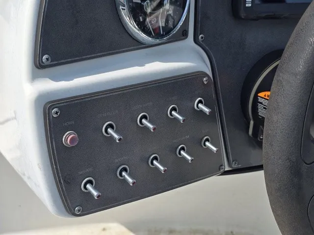 Slide: The Image of Close-up of a boat control panel with multiple toggle switches and a gauge. - 22