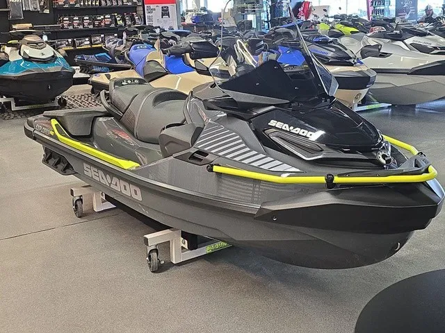 Slide: The Image of A Sea-Doo Explorer Pro 2026 in a showroom, surrounded by other watercraft. - 4