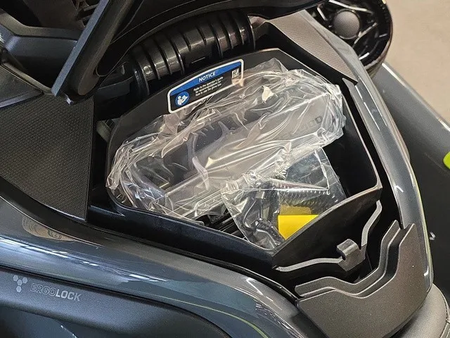 Slide: The Image of A 2026 Sea-Doo Explorer Pro with an open front storage compartment lid showing packaged items. - 15