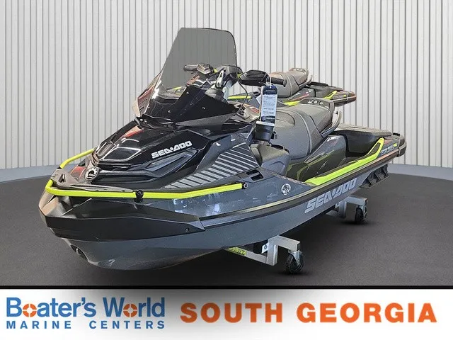 The Image of A Sea-Doo Explorer Pro 2026 jet ski is displayed in a showroom on a rolling cart. - 1
