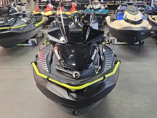 Slide: The Image of A Sea-Doo Explorer Pro 2026 jet ski is in a showroom, surrounded by other watercraft. - 3