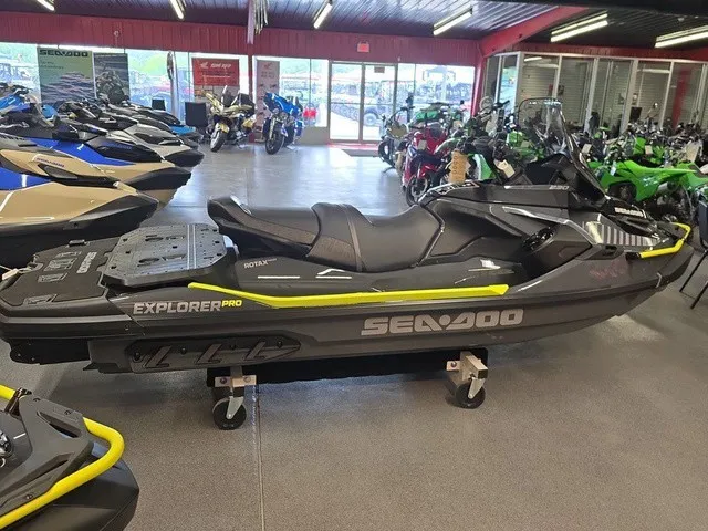 Slide: The Image of A Sea-Doo Explorer Pro 2026 jet ski is in a showroom, surrounded by other vehicles. - 5