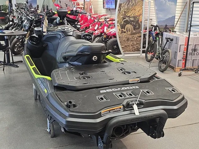 Slide: The Image of A Sea-Doo Explorer Pro 2026 jet ski is in a showroom, surrounded by other vehicles. - 8