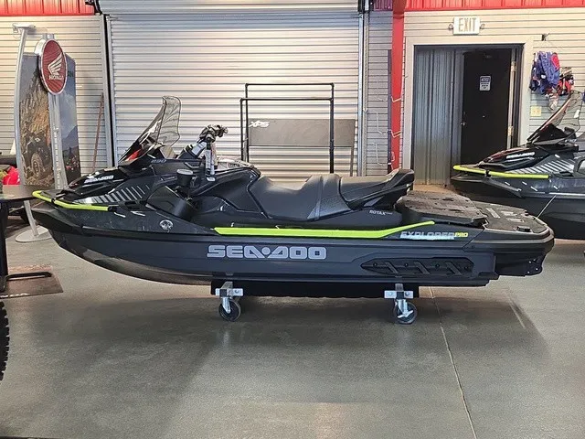 Slide: The Image of A Sea-Doo Explorer Pro 2026 jet ski is displayed in a showroom on a rolling cart. - 9