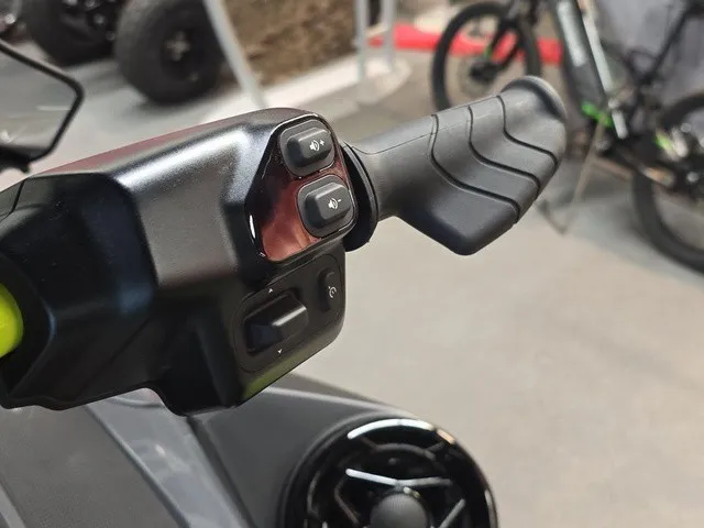 Slide: The Image of Close-up of the handlebar on a 2026 Sea-Doo Explorer Pro with control buttons. - 13