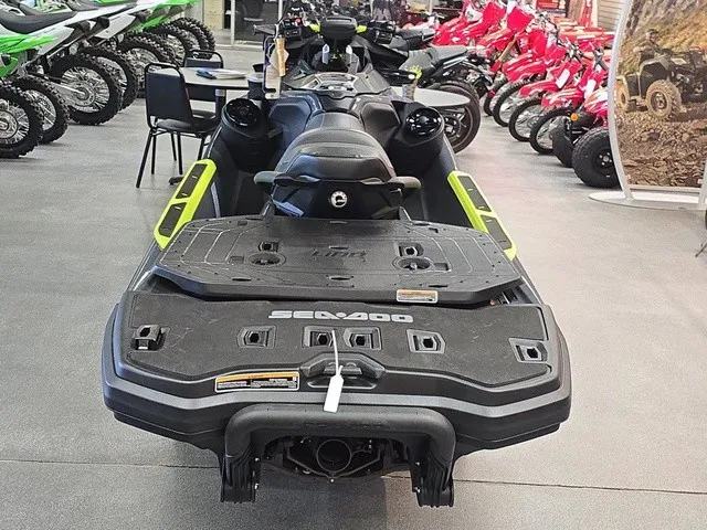 Slide: The Image of A Sea-Doo Explorer Pro 2026 is in a showroom, surrounded by other vehicles. - 7