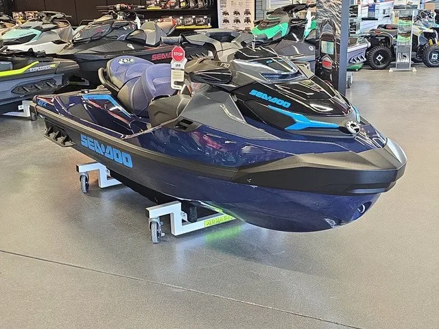 Slide: The Image of A 2026 Sea-Doo GTX 170 jet ski in a showroom, surrounded by other personal watercraft. - 4