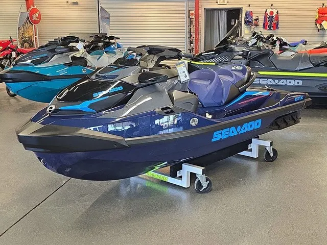 Slide: The Image of A 2026 Sea-Doo GTX 170 jet ski is displayed in a showroom on a rolling stand. - 2