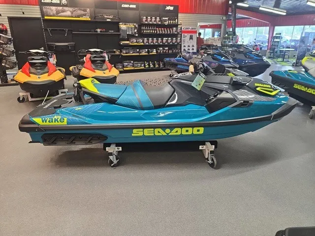 Slide: The Image of A 2026 Sea-Doo Wake Pro 230 jet ski is displayed on a stand in a showroom. - 5