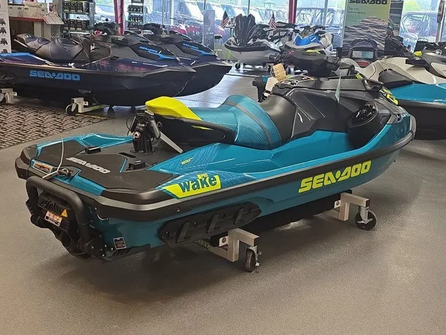Slide: The Image of A 2026 Sea-Doo Wake Pro 230 jet ski is displayed on a dolly in a showroom. - 6