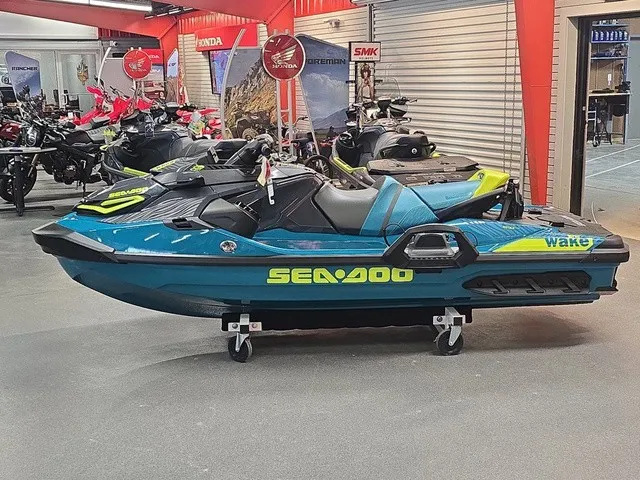 Slide: The Image of A 2026 Sea-Doo Wake Pro 230 jet ski is displayed in a showroom on a rolling cart. - 9