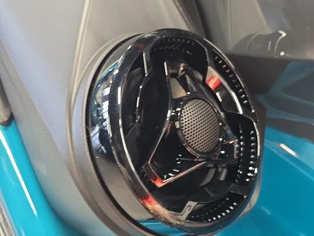 Slide: The Image of Close-up of a shiny black speaker on a blue Sea-Doo Wake Pro 230. - 12