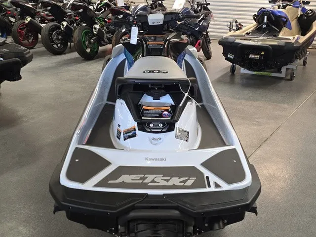 Slide: The Image of A 2026 Kawasaki Jet Ski STX is displayed in a showroom, surrounded by other vehicles. - 7