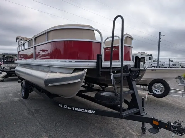 Slide: The Image of A red pontoon boat on a trailer with beige railings, ready for transport. - 4