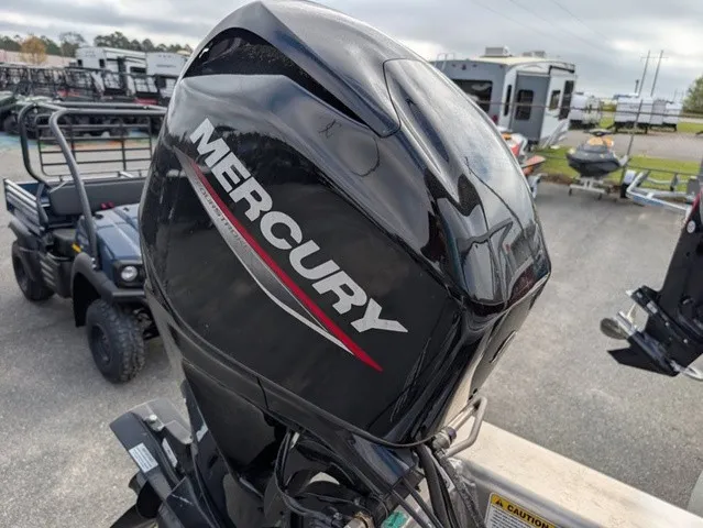Slide: The Image of A Mercury outboard motor is attached to a boat on a trailer. Vehicles are visible in the background. - 21