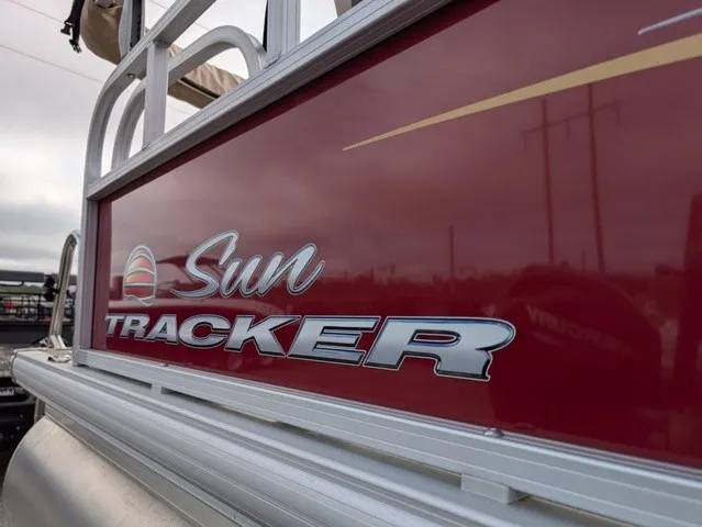Slide: The Image of Close-up of Sun Tracker Party Barge 18 DLX with red hull and silver logo. - 23