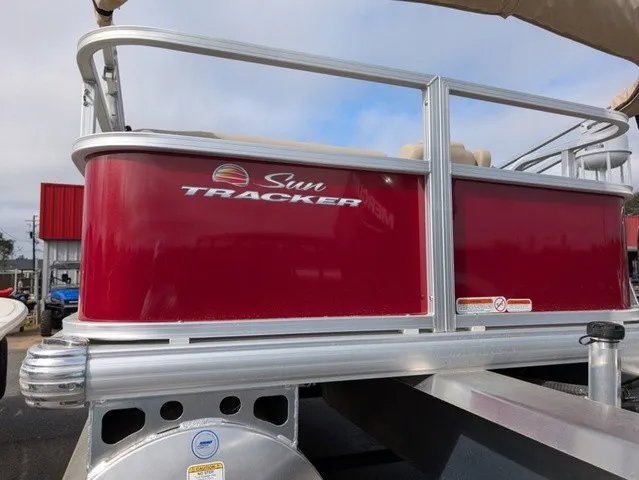Slide: The Image of A red pontoon boat by Sun Tracker with silver railings and a sunshade. - 29