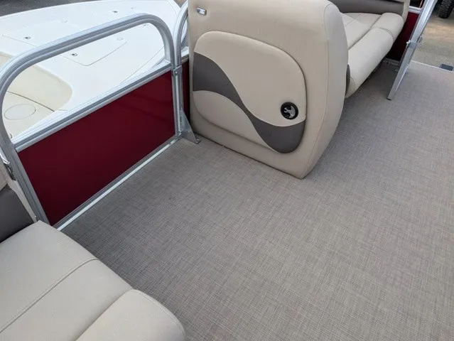 Slide: The Image of Interior of a 2025 Sun Tracker Party Barge 18 DLX with beige seating and carpeted floor. - 19