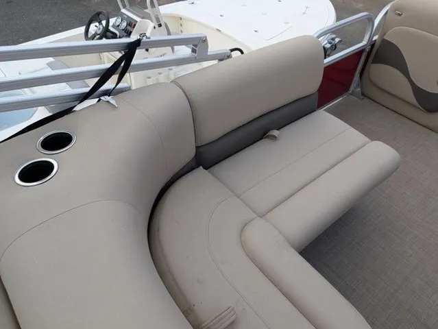 Slide: The Image of The image shows the beige seating of a 2025 Sun Tracker Party Barge 18 DLX. - 15