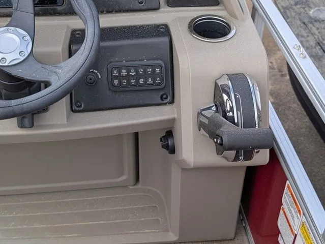 Slide: The Image of Close-up of a Sun Tracker Party Barge 18 DLX helm with steering wheel and controls. - 17