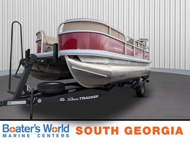 The Image of 2025 Sun Tracker Party Barge 18 DLX on a trailer in a showroom. - 1