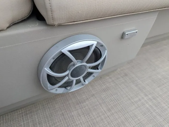 Slide: The Image of A speaker is embedded in the side panel of a boat, next to a small metal handle. - 7