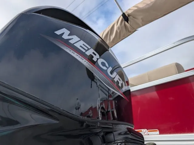 Slide: The Image of A Mercury outboard motor is mounted on a red Sun Tracker Party Barge 18 DLX boat. - 27