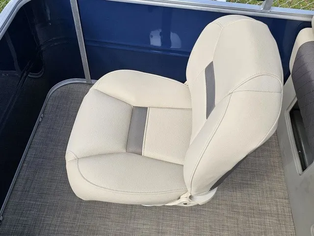 Slide: The Image of A beige boat seat on a gray carpeted floor, surrounded by blue walls. - 12