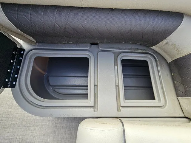 Slide: The Image of A gray storage compartment with two sections in a boat, surrounded by cushioned seating. - 30