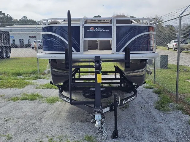 Slide: The Image of A 2025 Sun Tracker Fishin' Barge 20 DLX on a trailer in a gravel lot. - 8