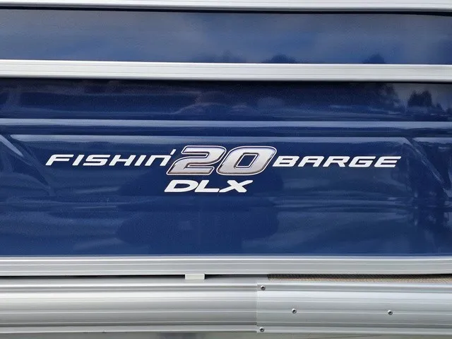Slide: The Image of Close-up of the "Fishin' Barge 20 DLX" nameplate on a blue boat hull. - 7