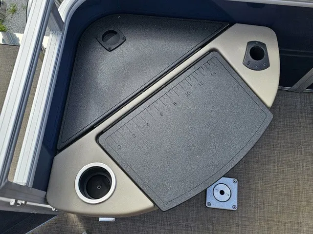 Slide: The Image of A fishing area on a Sun Tracker Fishin' Barge 20 DLX with cup holder and measuring scale. - 11