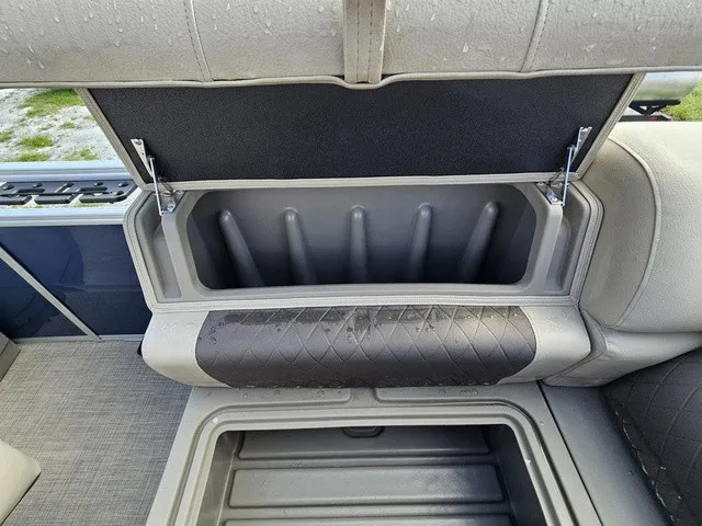 Slide: The Image of An open storage compartment on a boat with cushioned seating and a gray interior. - 28