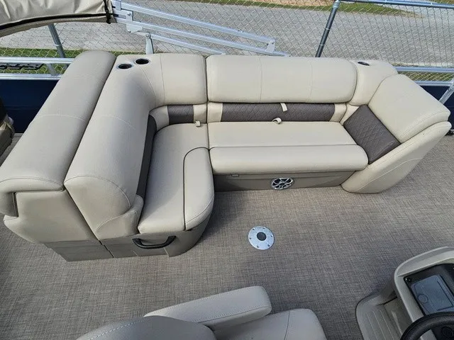 Slide: The Image of The image shows a beige corner bench on a boat with carpeted flooring and a cup holder. - 14