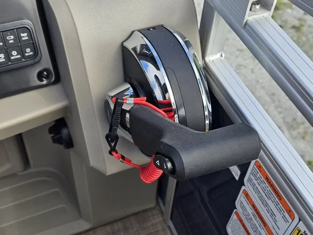 Slide: The Image of Close-up of a throttle lever on a 2025 Sun Tracker Fishin' Barge 20 DLX. - 24