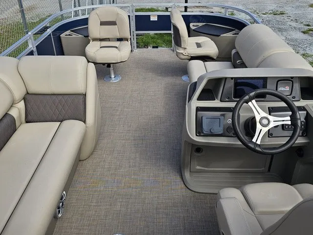 Slide: The Image of The image shows the spacious deck of a 2025 Sun Tracker Fishin' Barge 20 DLX with comfortable seating. - 13
