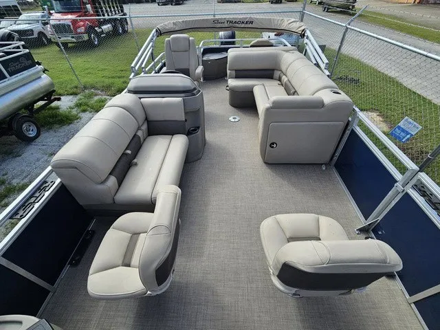 Slide: The Image of The image shows the spacious deck of a 2025 Sun Tracker Fishin' Barge 20 DLX with comfortable seating. - 26
