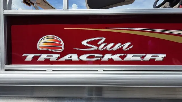 Slide: The Image of Close-up of the Sun Tracker logo on a red boat. - 27