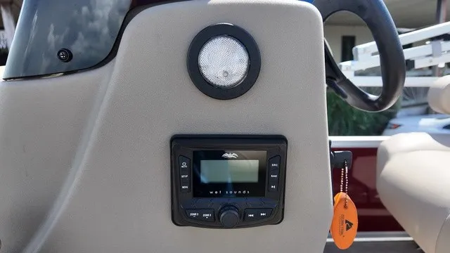 Slide: The Image of Close-up of a boat dashboard featuring a Wet Sounds audio system and a round speaker. - 14