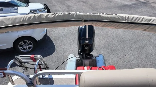 Slide: The Image of The image shows the rear of a Sun Tracker Bass Buggy 16 XL Select with an outboard motor. - 21